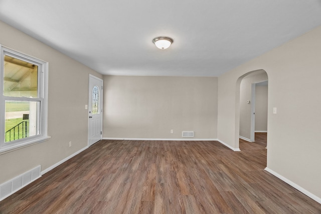 7832 Main St, Walsh, IL 62297 - spare room with arched walkways, wood finished floors, and baseboards