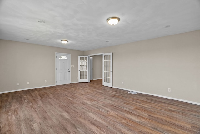 7832 Main St, Walsh, IL 62297 - spare room with baseboards, wood finished floors, and french doors