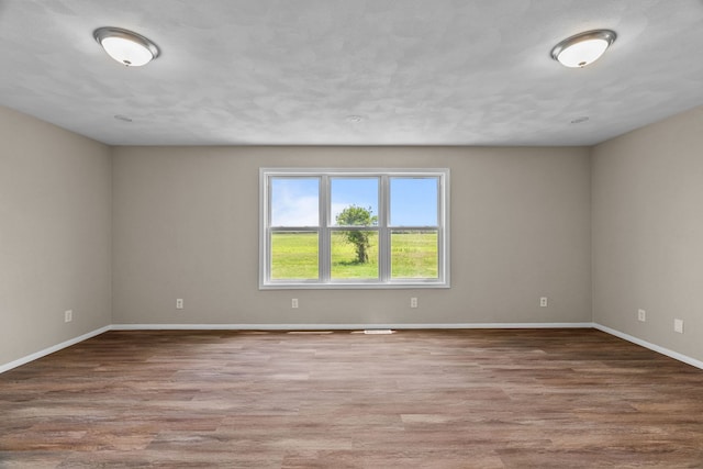 7832 Main St, Walsh, IL 62297 - empty room featuring wood finished floors and baseboards