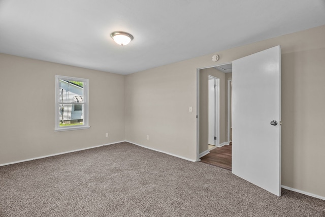 7832 Main St, Walsh, IL 62297 - empty room with dark carpet, baseboards, and a smoke detector