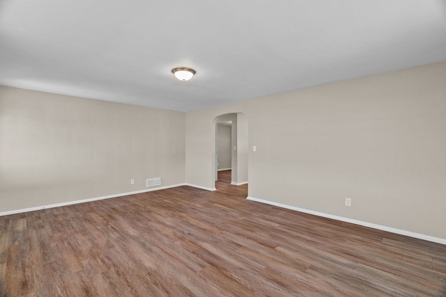 7832 Main St, Walsh, IL 62297 - unfurnished room with arched walkways, baseboards, and wood finished floors