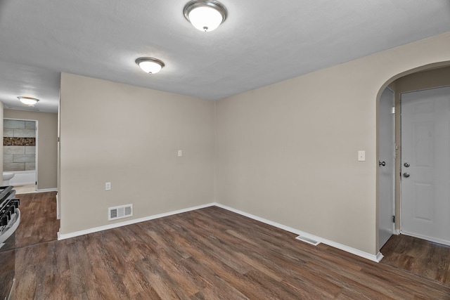 7832 Main St, Walsh, IL 62297 - empty room featuring arched walkways, wood finished floors, and baseboards