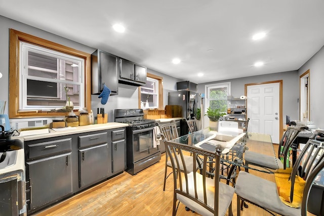 4926 S Winchester Ave, Chicago, IL 60609 - kitchen featuring black gas stove, light wood finished floors, recessed lighting, refrigerator with ice dispenser, and light countertops