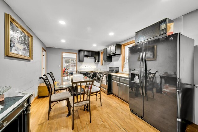 4926 S Winchester Ave, Chicago, IL 60609 - kitchen with black refrigerator with ice dispenser, gas stove, light wood-style flooring, recessed lighting, and light countertops