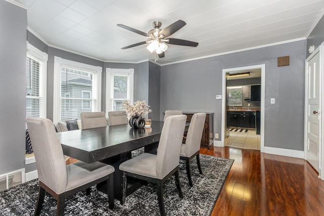 614 Oak Ave, Aurora, IL 60506 - dining room featuring ornamental molding, wood finished floors, a ceiling fan, and baseboards