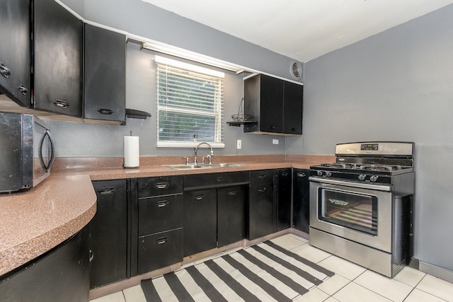 614 Oak Ave, Aurora, IL 60506 - kitchen with stainless steel range with gas cooktop, dark cabinets, a sink, black microwave, and vaulted ceiling