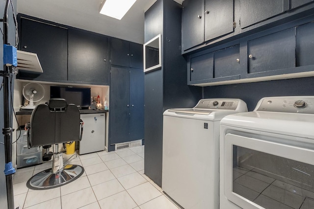 614 Oak Ave, Aurora, IL 60506 - laundry room featuring cabinet space, washer and dryer, and light tile patterned floors