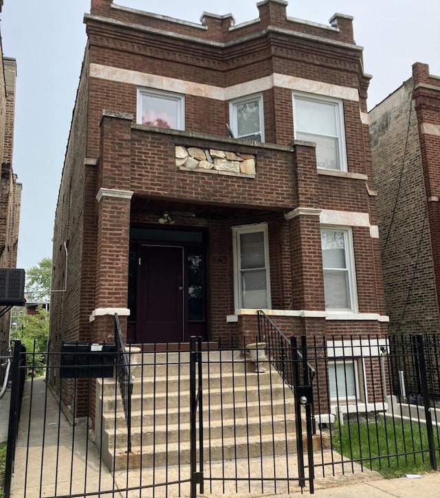 641 N Spaulding Ave, Chicago, IL 60624 - front facade with brick siding, a fenced front yard, and a gate