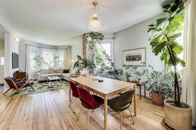 3719 W Shakespeare Ave, Chicago, IL 60647 - dining space featuring light wood finished floors and a chandelier
