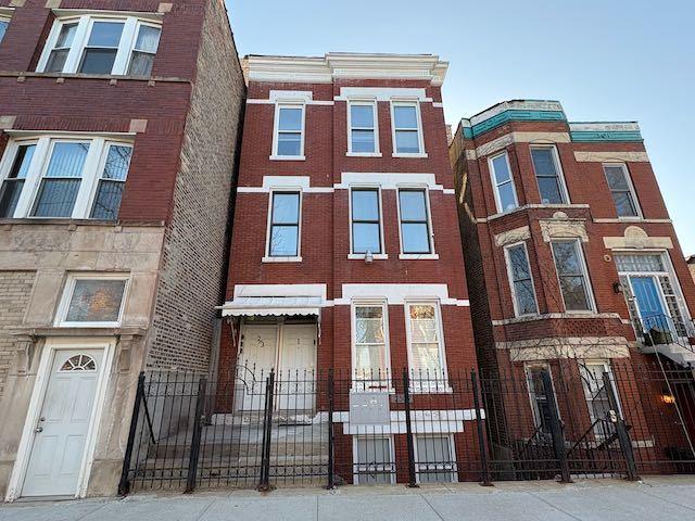 2307 S Leavitt St, Chicago, IL 60608 - view of front of property featuring a fenced front yard and brick siding