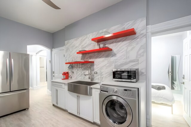 2307 S Leavitt St, Chicago, IL 60608 - kitchen with washer / clothes dryer, stainless steel appliances, open shelves, a sink, and tasteful backsplash