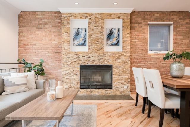 2433 W Haddon Ave Unit 1E, Chicago, IL 60622 - living area with wood finished floors, crown molding, brick wall, a glass covered fireplace, and recessed lighting