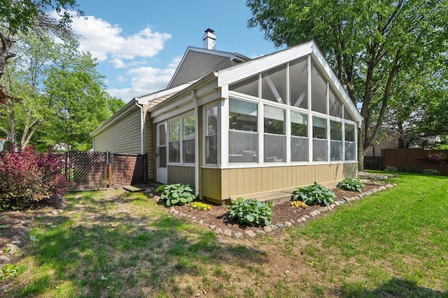 2313 Modaff Rd, Naperville, IL 60565 - view of side of home featuring a sunroom and a chimney