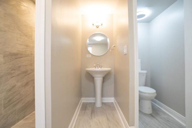 14117 S Calhoun Ave, Burnham, IL 60633 - bathroom with toilet, baseboards, and a sink
