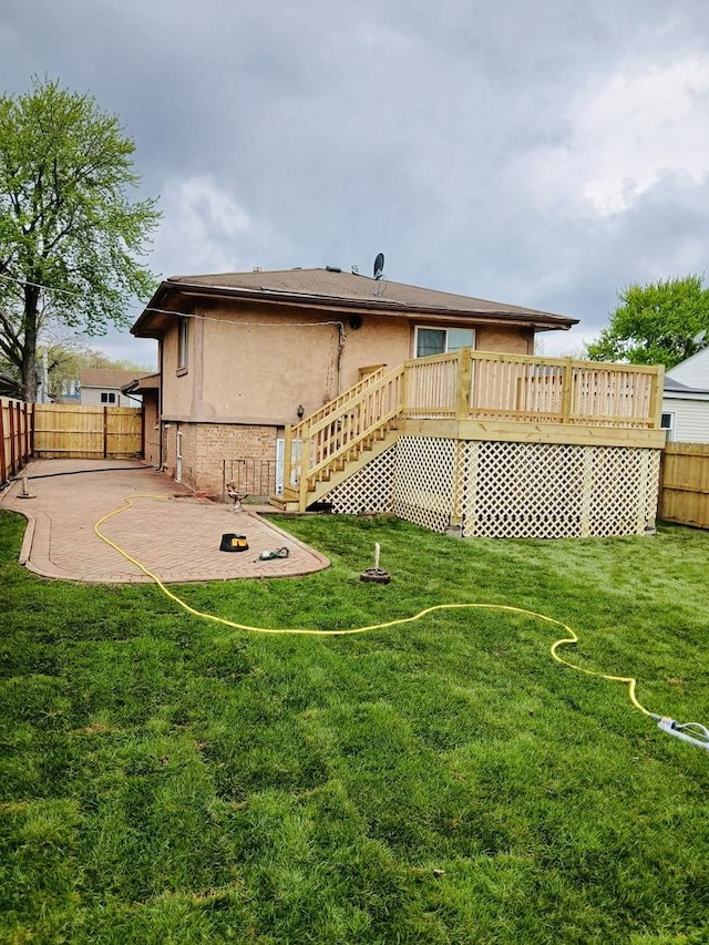 14117 S Calhoun Ave, Burnham, IL 60633 - rear view of house with stairway, a deck, stucco siding, and a patio area