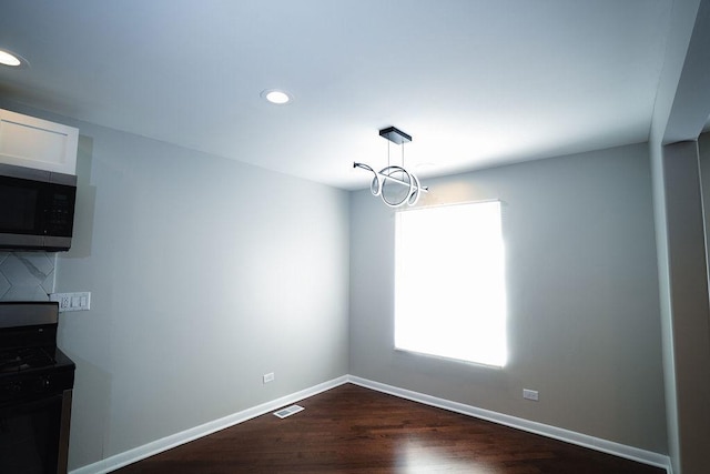 14117 S Calhoun Ave, Burnham, IL 60633 - unfurnished dining area with recessed lighting, baseboards, and dark wood finished floors
