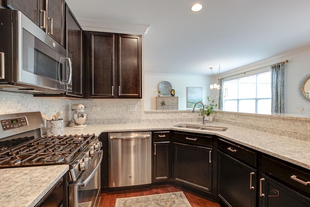 769 N Winchester Dr, Palatine, IL 60067 - kitchen featuring stainless steel appliances, a sink, dark wood finished floors, ornamental molding, and dark brown cabinetry