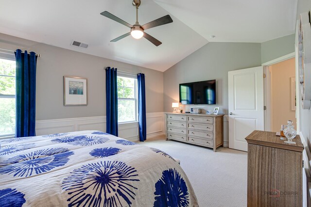 769 N Winchester Dr, Palatine, IL 60067 - bedroom with wainscoting, vaulted ceiling, light carpet, and a ceiling fan