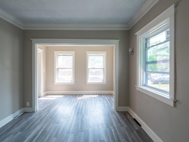 8950 S Bishop St, Chicago, IL 60620 - unfurnished room with crown molding, dark wood-style flooring, healthy amount of natural light, a textured ceiling, and baseboards