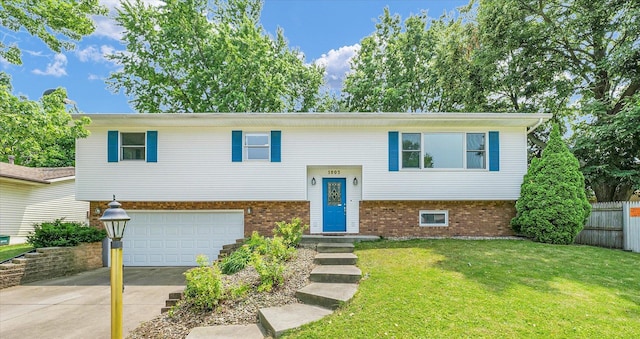 1803 Galena St, Urbana, IL 61802 - raised ranch featuring concrete driveway, an attached garage, and brick siding