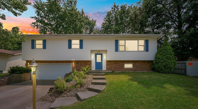 1803 Galena St, Urbana, IL 61802 - split foyer home with a garage, concrete driveway, and brick siding