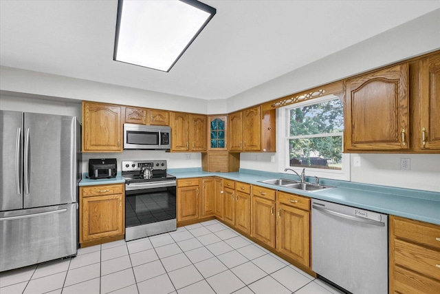 1803 Galena St, Urbana, IL 61802 - kitchen with appliances with stainless steel finishes, brown cabinets, light tile patterned floors, and light countertops
