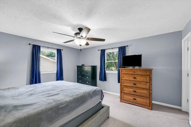 1803 Galena St, Urbana, IL 61802 - bedroom featuring multiple windows, carpet flooring, ceiling fan, and a textured ceiling