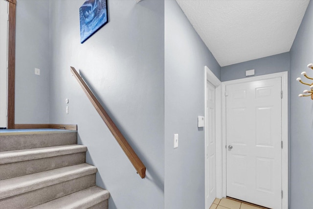 1803 Galena St, Urbana, IL 61802 - staircase with tile patterned floors and a textured ceiling