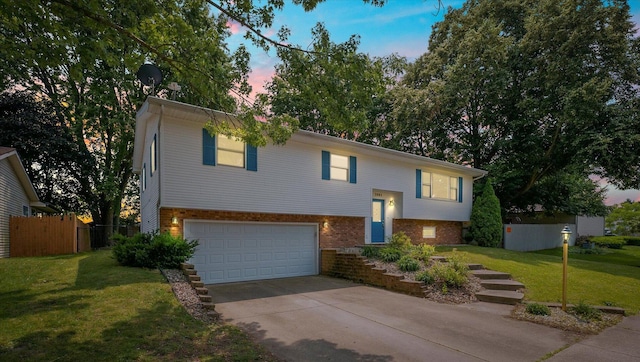 1803 Galena St, Urbana, IL 61802 - split foyer home with a garage, brick siding, and concrete driveway