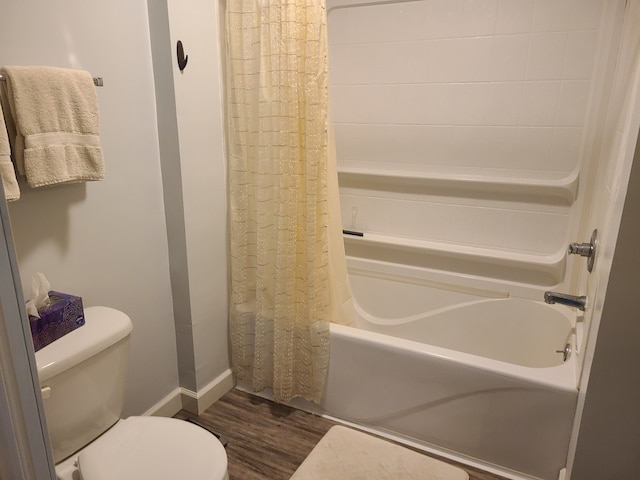 100 Watson Ave, Oglesby, IL 61348 - bathroom featuring wood finished floors, shower / bathtub combination with curtain, toilet, and baseboards