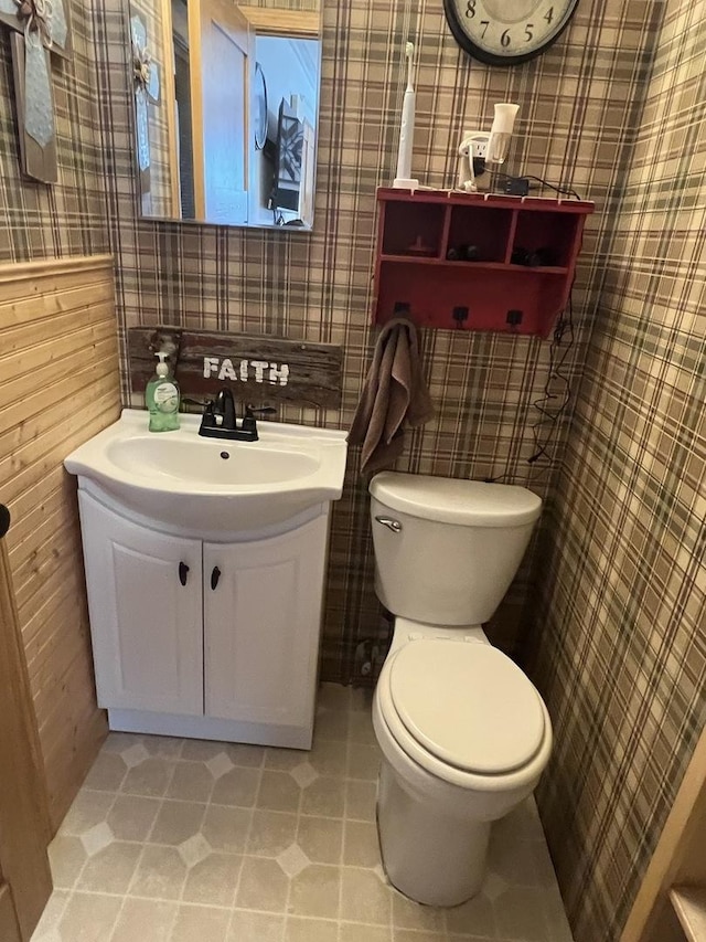 806 N Elizabeth St, Clinton, IL 61727 - half bath with toilet, wallpapered walls, tile patterned floors, and vanity