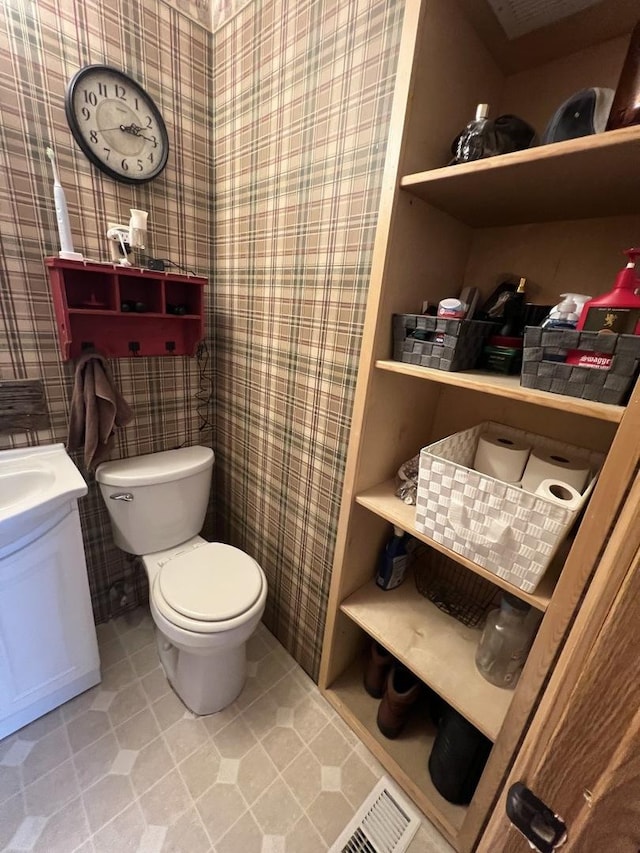 806 N Elizabeth St, Clinton, IL 61727 - bathroom featuring wallpapered walls, toilet, vanity, and tile patterned flooring