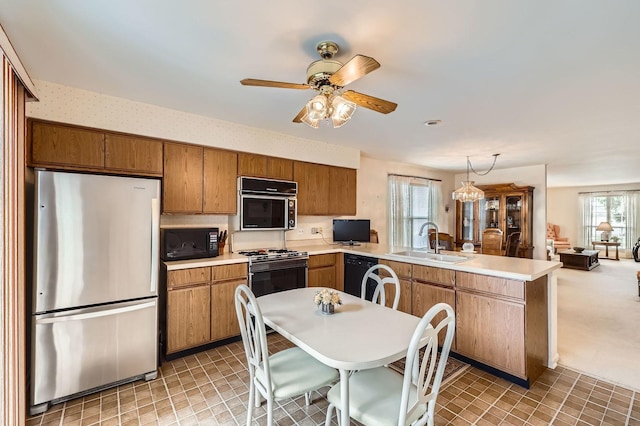 1232 Sumac Trl, Hoffman Estates, IL 60192 - kitchen with black appliances, a sink, a peninsula, and brown cabinets