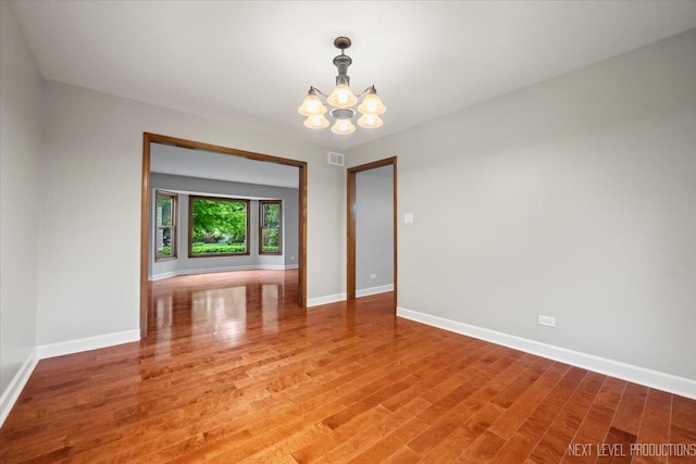 2556 Leach Dr, Naperville, IL 60564 - spare room with a chandelier, light wood-style flooring, and baseboards