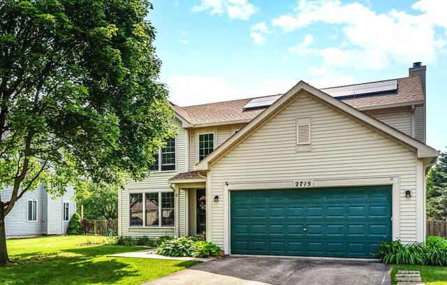 2715 Lahinch Dr, Aurora, IL 60503 - traditional-style home featuring driveway, an attached garage, solar panels, and a shingled roof