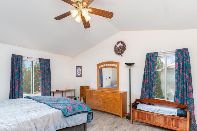 2715 Lahinch Dr, Aurora, IL 60503 - bedroom featuring vaulted ceiling, multiple windows, wood finished floors, and a ceiling fan