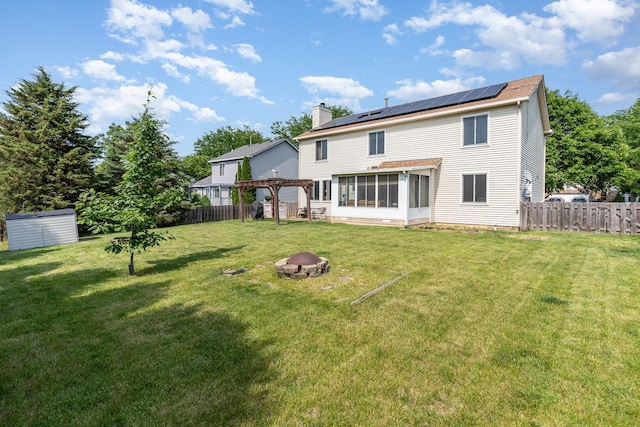 2715 Lahinch Dr, Aurora, IL 60503 - rear view of house featuring a fire pit, a sunroom, solar panels, a pergola, and a chimney