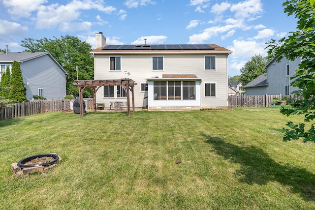 2715 Lahinch Dr, Aurora, IL 60503 - back of house with a pergola, roof mounted solar panels, a chimney, and a fenced backyard
