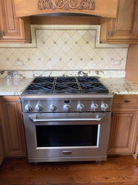 473 S Edgewood Ave, Wood Dale, IL 60191 - kitchen view of high end stainless steel range, decorative backsplash, light stone counters, and brown cabinetry