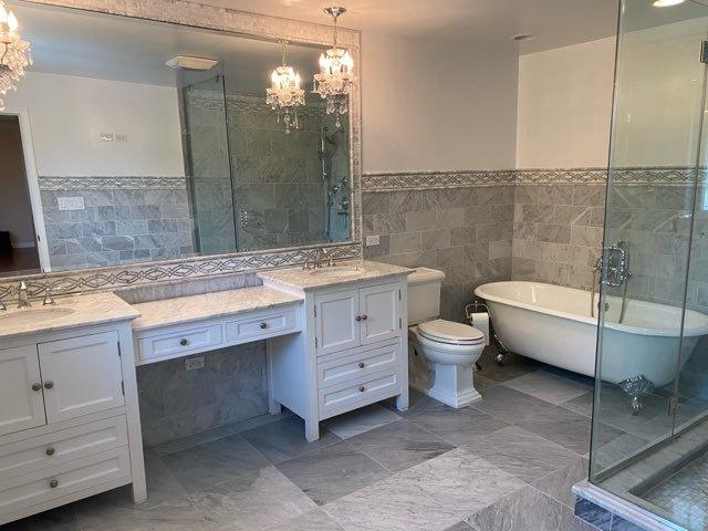 473 S Edgewood Ave, Wood Dale, IL 60191 - full bathroom with tile walls, a chandelier, vanity, a freestanding bath, and toilet
