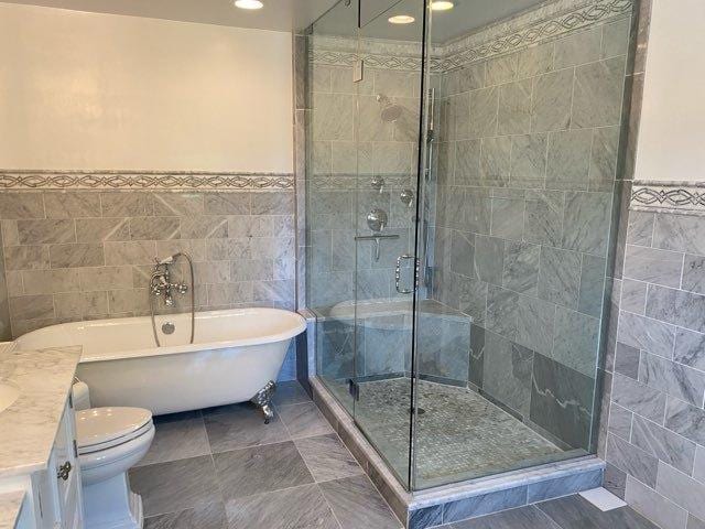 473 S Edgewood Ave, Wood Dale, IL 60191 - bathroom with tile walls, a freestanding tub, vanity, a shower stall, and toilet