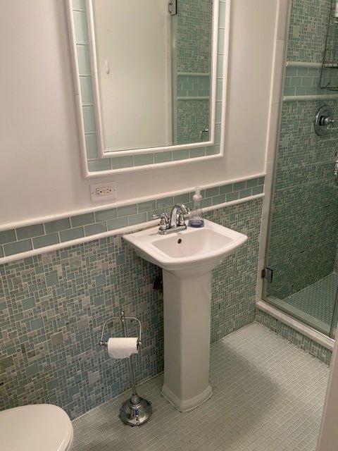 473 S Edgewood Ave, Wood Dale, IL 60191 - full bathroom with tile walls, a stall shower, toilet, tile patterned flooring, and wainscoting