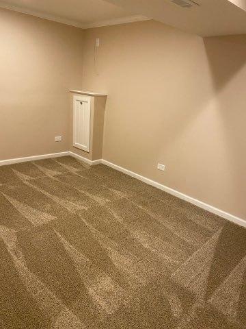 473 S Edgewood Ave, Wood Dale, IL 60191 - unfurnished room with baseboards, dark colored carpet, and crown molding