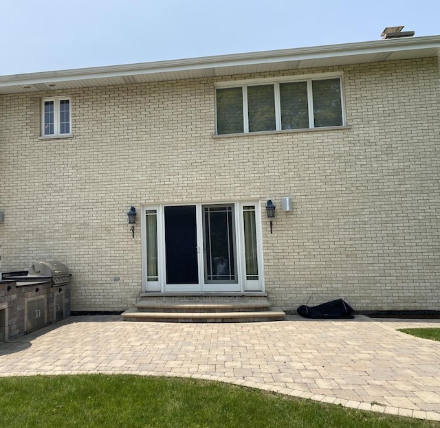 473 S Edgewood Ave, Wood Dale, IL 60191 - rear view of house with entry steps, a patio area, area for grilling, and brick siding