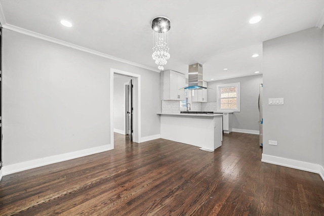 9012 S Harper Ave, Chicago, IL 60619 - kitchen with island range hood, a peninsula, baseboards, white cabinets, and dark wood-style flooring