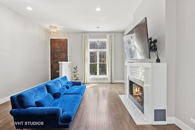 3342 S Giles Ave, Chicago, IL 60616 - living area featuring a fireplace with flush hearth, baseboards, wood finished floors, and recessed lighting