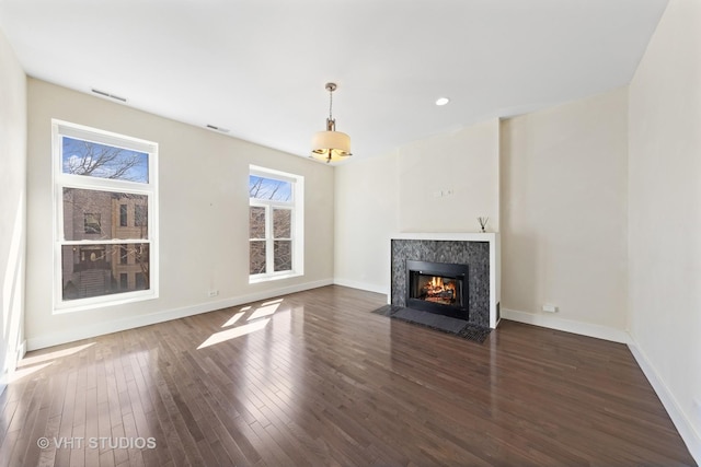 3342 S Giles Ave, Chicago, IL 60616 - unfurnished living room featuring wood finished floors, a fireplace, baseboards, and recessed lighting