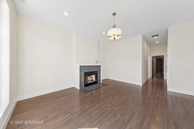 3342 S Giles Ave, Chicago, IL 60616 - unfurnished living room featuring wood finished floors, baseboards, a premium fireplace, and recessed lighting