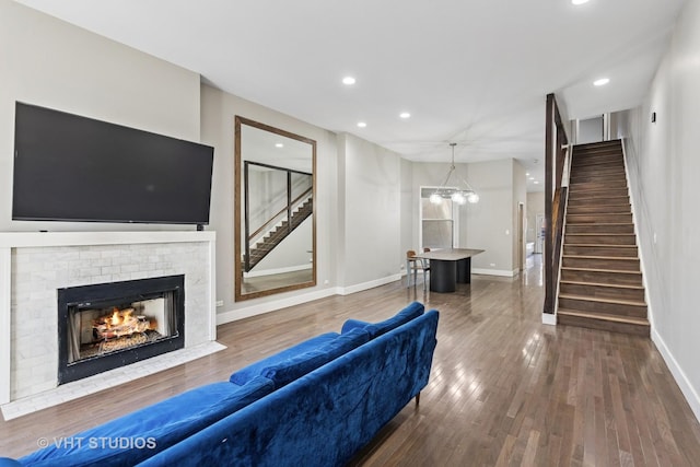 3342 S Giles Ave, Chicago, IL 60616 - living room featuring stairs, baseboards, recessed lighting, wood finished floors, and a fireplace