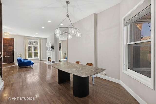 3342 S Giles Ave, Chicago, IL 60616 - dining space featuring dark wood-style flooring, baseboards, recessed lighting, a chandelier, and a warm lit fireplace